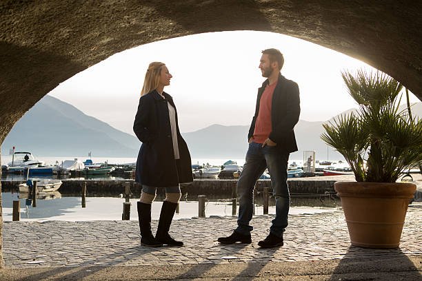 View from tunnel of couple in conversation, Autumn in Switzerland